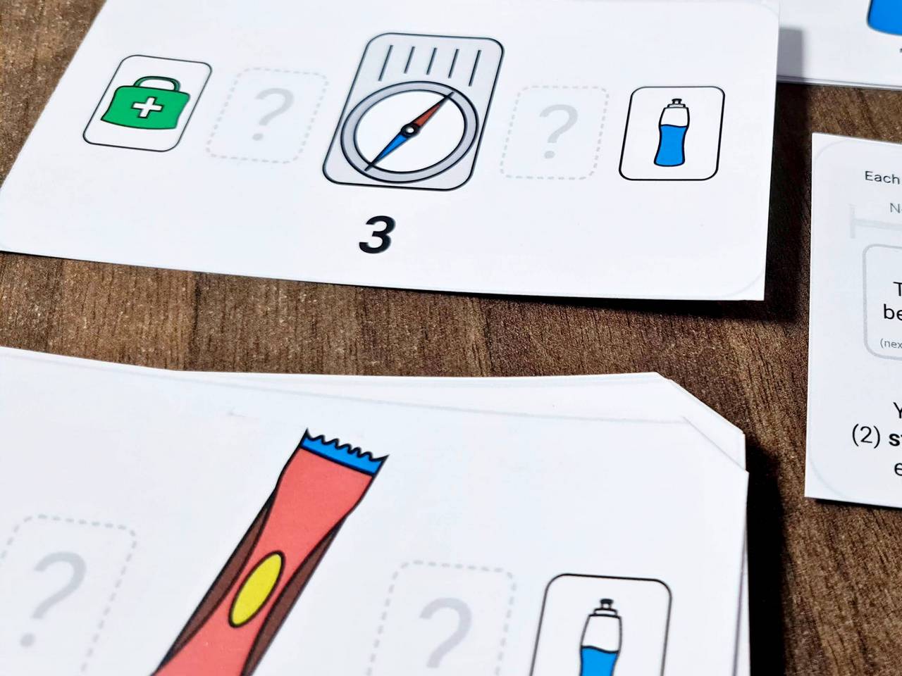 Game cards for Pack it Up, with icons showing a compass, water bottle, and other kit